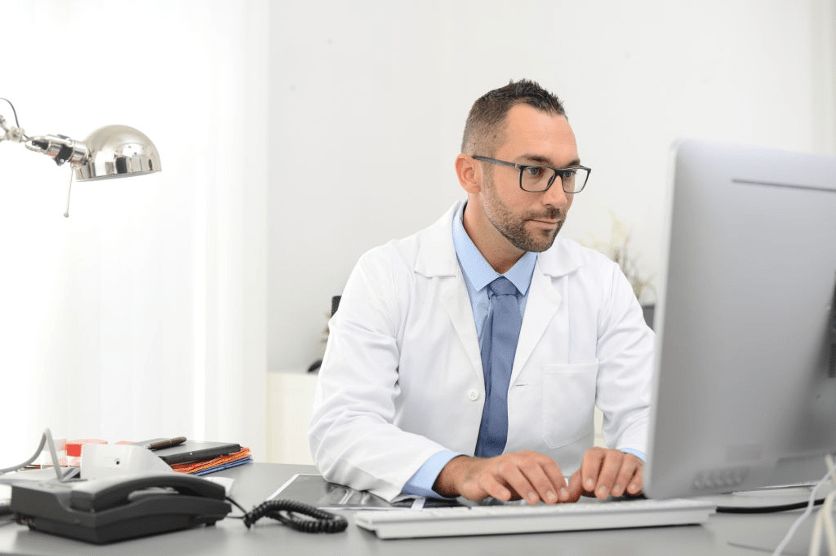 a male doctor working at desk