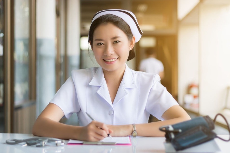 an Asian female nurse is smiling